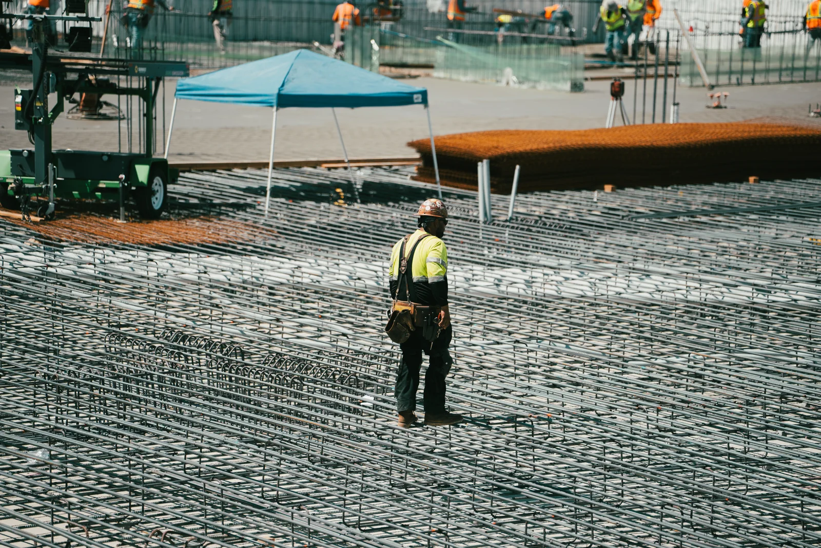Worker surveying a concrete deck during a pour