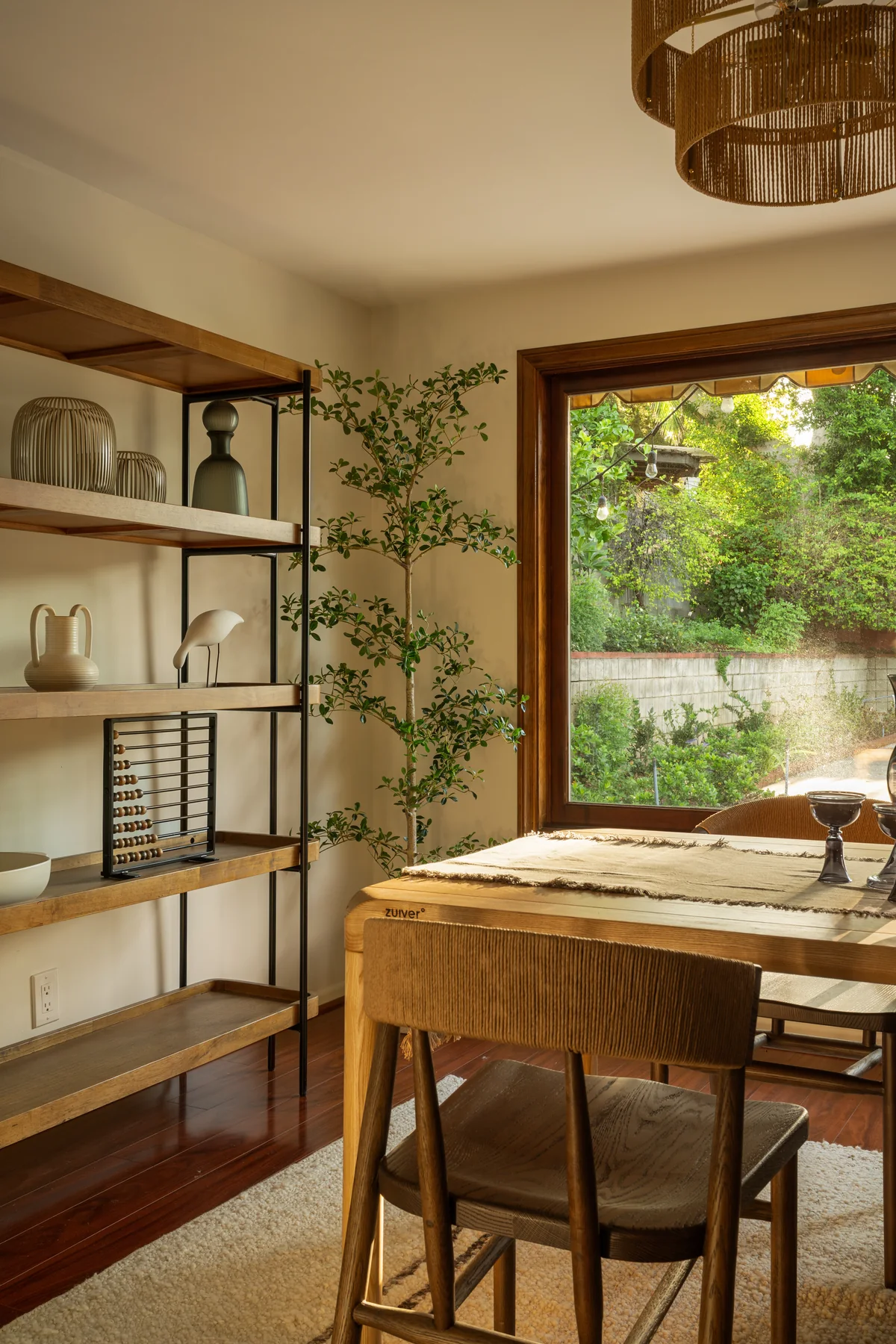 Dining room framed by garden-facing windows