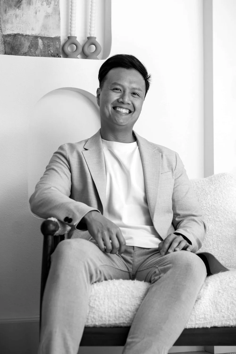 Jason Lu, the filmmaker behind ilu.films, seated in a light blazer and smiling